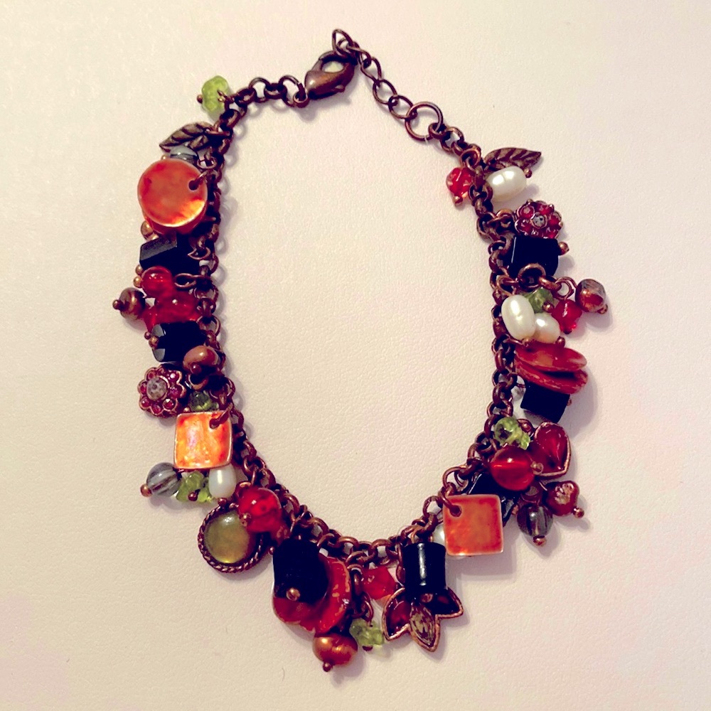 Vintage charm bracelet in copper green ruby tones with tons of beads and dangles